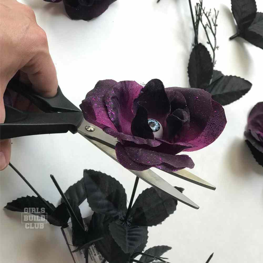 Cut off the heads of the plastic flowers for the diy halloween wreath